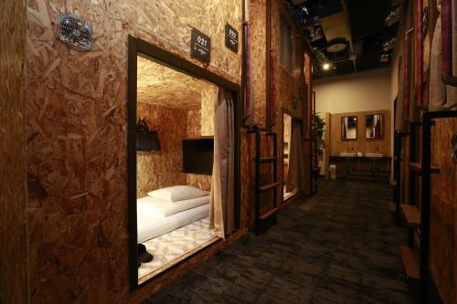 a mirror in a room with a bed in it at eeGee STAY Omiya in Saitama