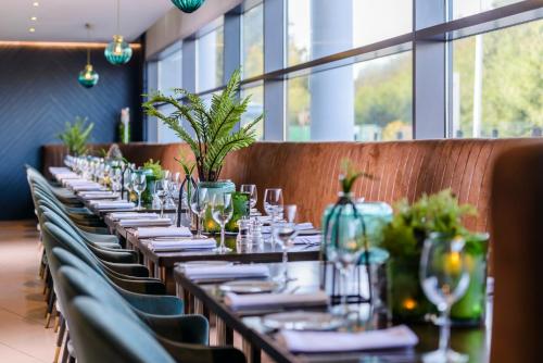 a long table in a restaurant with plates and glasses at The Ellison in Castlebar