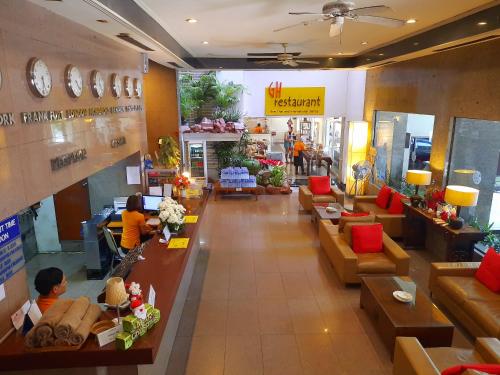 a restaurant with people sitting at tables in a room at Grand Hotel in Pattaya South