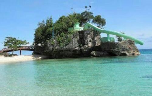 a slide in the middle of the water on a beach at First Baby Bytes Guest House in Siquijor