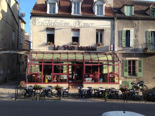 a restaurant with tables and chairs in front of a building at Pub vauban terreaux in Avallon
