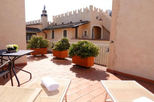 un patio con mesas y macetas y un edificio en Agriturismo del Pigato - Bio Vio en Albenga