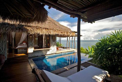 a resort with a swimming pool next to the ocean at View Point Resort in Koh Tao