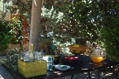 a picnic table with bowls of fruit and juice on it at Villieta Marina in Vaia