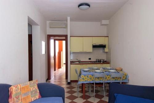 a living room with a table and a kitchen at Giada in Moneglia