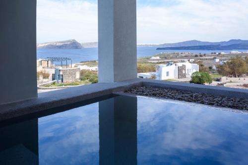 a view of the ocean from the balcony of a building at Potnia Theron Suites in Akrotiri
