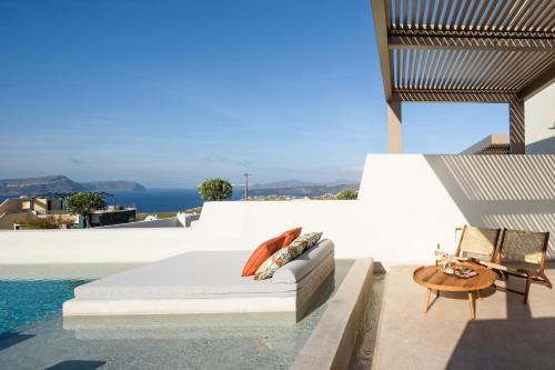 a bedroom on the roof of a house at Potnia Theron Suites in Akrotiri