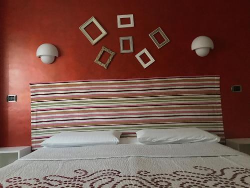 a bedroom with a large bed with a red wall at La casetta di Simone in Cassino