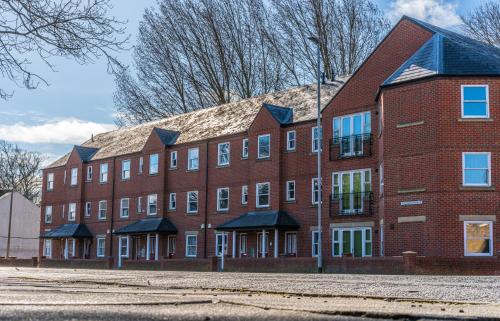 a large red brick building with a lot of windows at Pullman House in Darlington