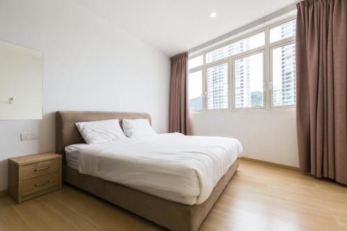 a bedroom with a bed and a large window at 118 Residences by Travovo in George Town