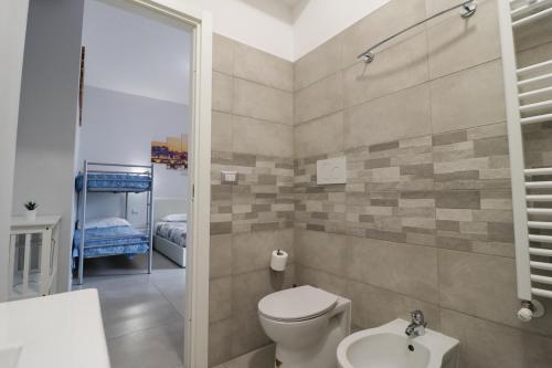 a bathroom with a toilet and a sink at Romanina Apartments in Rome