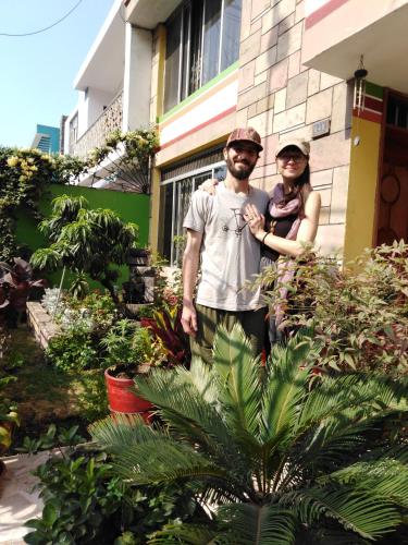 a man and a woman standing in front of a house at Hospedaje de Lidia in Lima