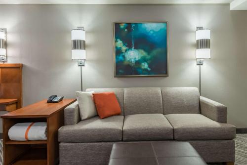 a living room with a couch and a table at Hyatt Place Bentonville Rogers in Rogers