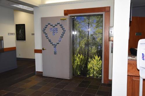 a door with a heart shaped sign on it at Wood River Inn & Suite in Hailey