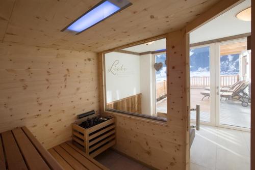 a wooden cabin with a window and a bench at Appartement Freiblick in Ramsau im Zillertal