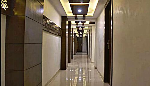 a hallway of a building with a long corridor at Hotel Amber Railway station in Vadodara