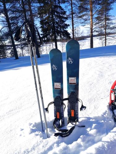 a pair of skis and ski poles in the snow at Goiglo Hotel & Hostel in Kuusamo