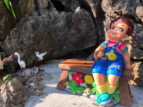 a figurine of a boy sitting on a bench at Khao Chang View Resort in Phangnga