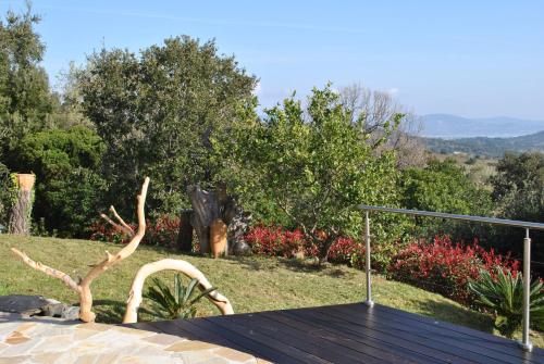 a wooden table with a sculpture of a tree at Luciana in La Croix-Valmer