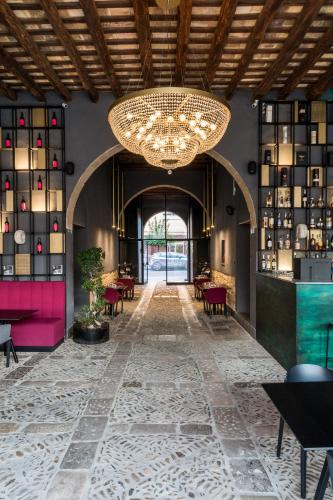a large chandelier in a room with tables and chairs at B&B Palazzo Corselli in Bagheria