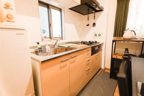 a kitchen with a sink and a stove at Chiba LEO Yonju-Yonbankan #MLx in Funabashi