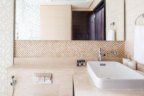 a bathroom with a white tub and a sink at Frank Porter - Mon Reve in Dubai