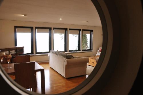 a living room with a couch and a table at Charming house with panoramic sea view over Bråviken! in Norrköping
