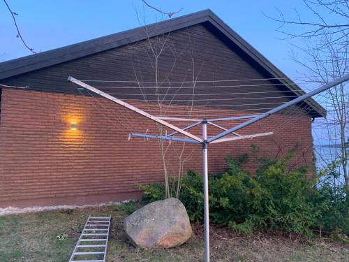 a metal structure in front of a brick building at Charming house with panoramic sea view over Bråviken! in Norrköping