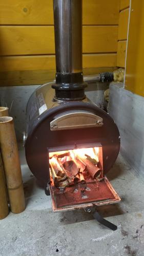 a brick oven with a fire in it at あかがね荘 in Sumino