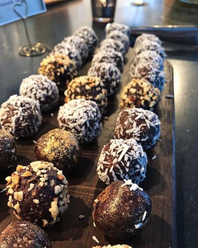 a tray of donuts with chocolate and sprinkles on it at Högbo Hotell Skommarsgården in Sandviken