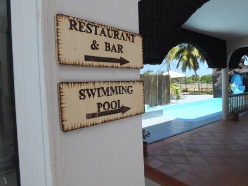 a sign that reads restaurant and bar swimming pool at Eden Villa in Belle Mare