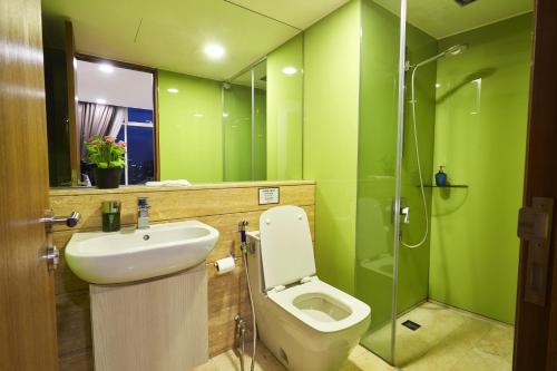 a bathroom with a toilet and a sink and a shower at Luxe Suites at Vortex KLCC in Kuala Lumpur