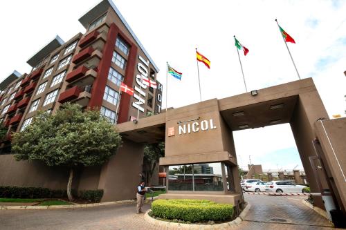 a man standing in front of a hotel at The Nicol Hotel and Apartments in Johannesburg