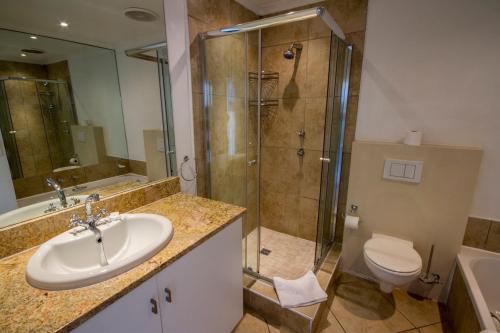 a bathroom with a sink and a shower and a toilet at Laguna Grove 48 in Knysna