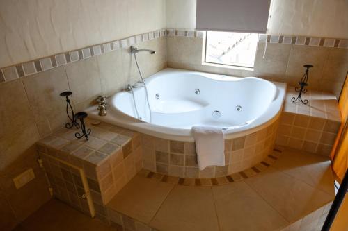 a bath tub in a bathroom with a window at Hosteria La Caldera in La Caldera