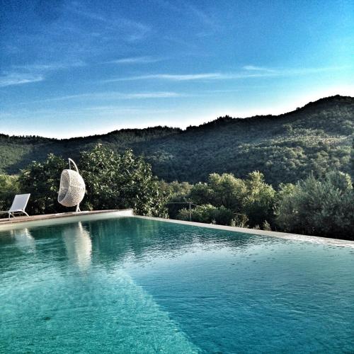 a swimming pool with a view of a mountain at Fonte Cicerum Authentic Villa - a Fontanaro Property in Paciano