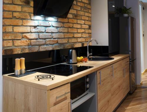 Kuchyňa alebo kuchynka v ubytovaní Kamienica Na Nowo Apartamenty