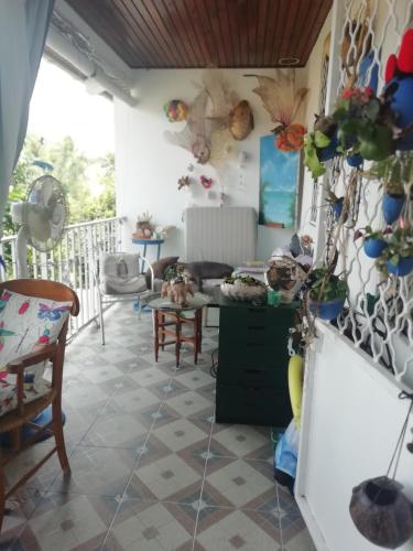 a living room with a tiled floor at Chambre d'hôte la Calebasse in Sainte-Anne