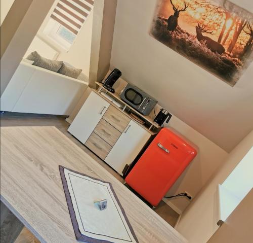 a small kitchen with a red refrigerator and a table at Landhotel Heidkrug in Munster im Heidekreis