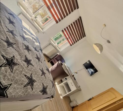 a bedroom with a bed with black stars on it at Landhotel Heidkrug in Munster im Heidekreis