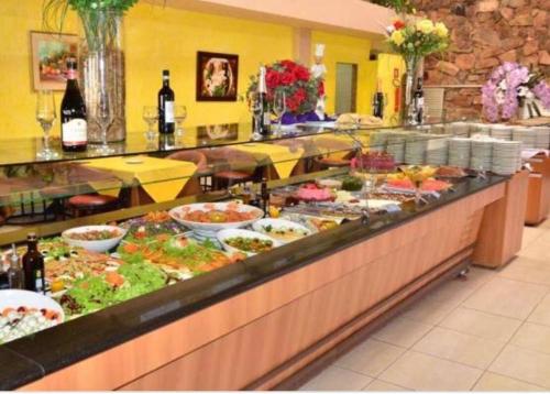 a buffet line with a lot of food on display at Apartamentos Caldas Novas in Caldas Novas