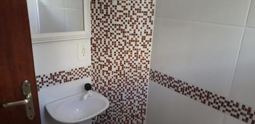 a bathroom with a sink and a mirror at Fort in Angra dos Reis