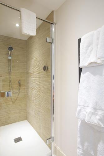 a bathroom with a shower with a glass door at Railway Apartments in Nailsworth