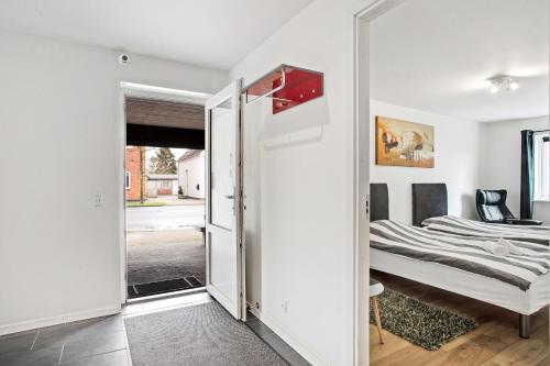 a bedroom with a bed and a sliding glass door at Just Sleep in Esbjerg