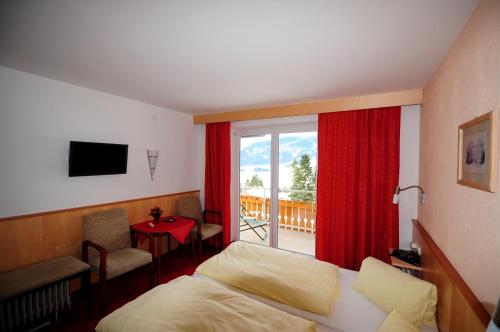 Schlafzimmer mit einem Bett und einem Fenster mit einem Balkon in der Unterkunft Tannenhof in Ehrwald