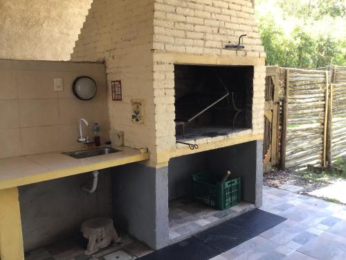 an outdoor kitchen with a sink and a counter at Cabañas de Bella Vista in Bella Vista