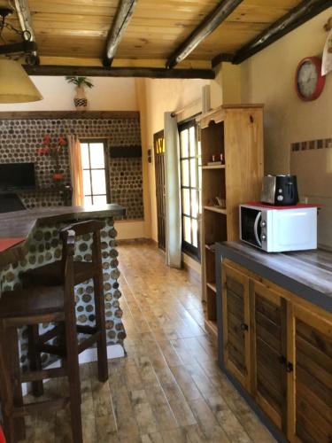 a kitchen with a counter with a microwave on it at Cabañas de Bella Vista in Bella Vista
