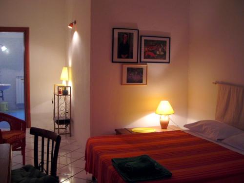 a bedroom with a bed with a lamp on it at B&B Ixia in Carolei