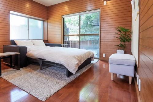 a bedroom with a bed and a large window at Annex Shibuya in Tokyo