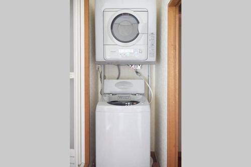 a microwave and a washing machine on top of a refrigerator at Annex Shibuya in Tokyo